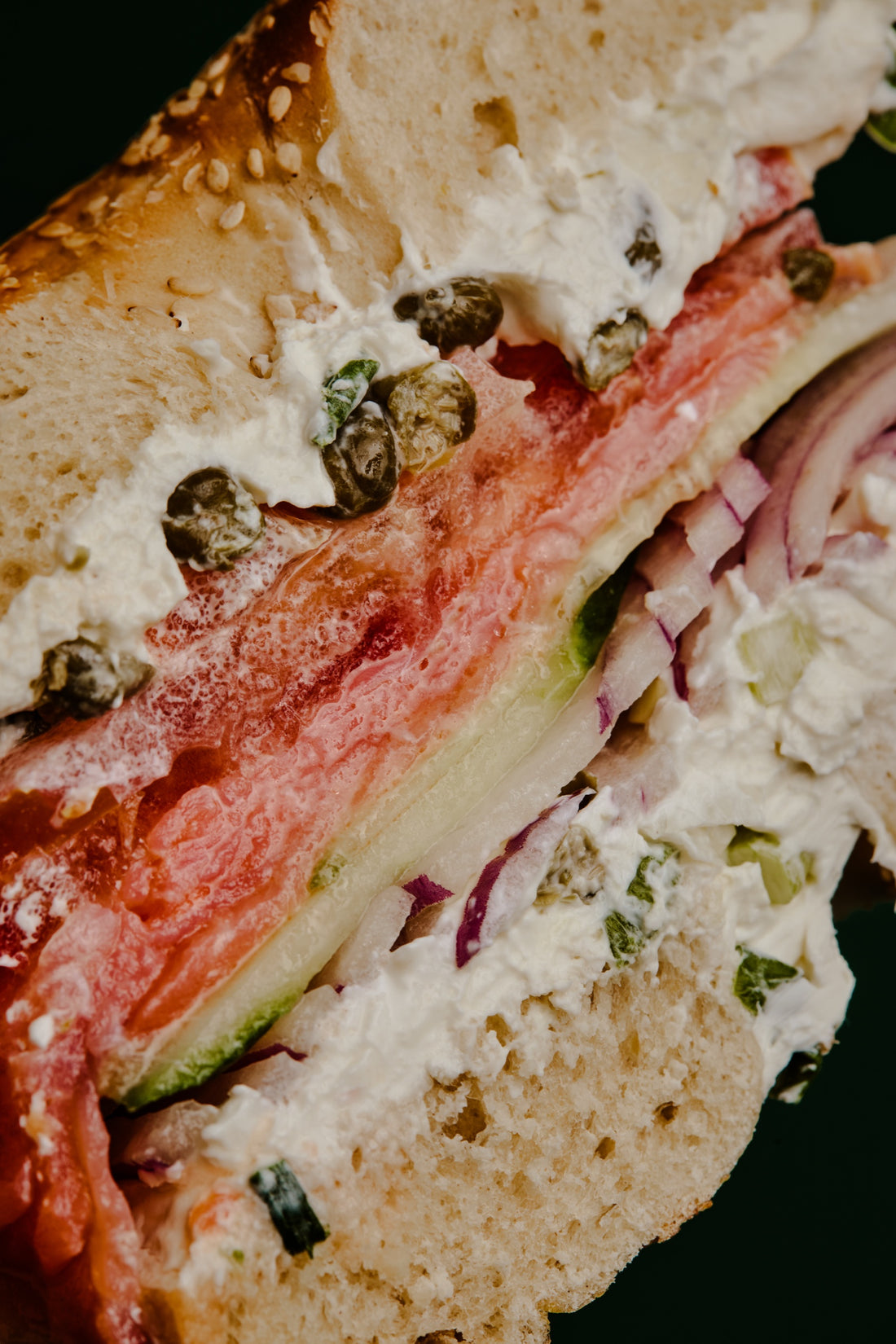 Smoked salmon, scallion cream cheese, capers, tomato, cucumber and red onion on a sesame bagel